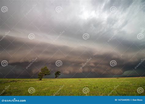 A Dark Supercell Storm With A Low Shelf Cloud Fills The Sky Over A