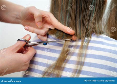 Haircut Mom Cuts Off Her Daughterand X27 S Hair With Scissors Stock