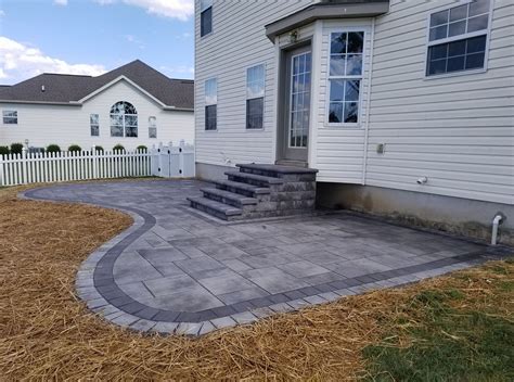 These steps lead right out onto this unique patio! Cambridge Pavers can help you every step of ...