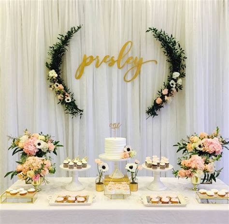 A Table Topped With Cakes And Cupcakes Next To A Sign That Says Pretty