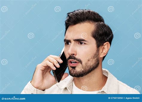 Portrait Of A Brunette Man Close Up Talking On The Phone Angry And