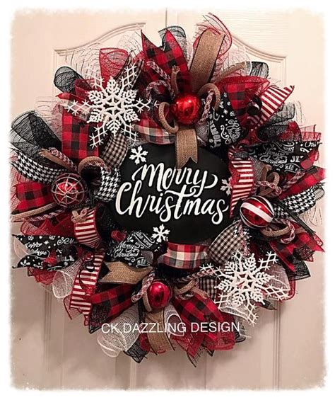 A Christmas Wreath On The Front Door With Red Black And White Plaid