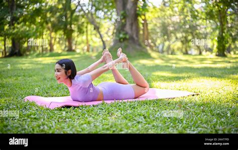 Healthy Young Asian Female In Sportswear Practicing Yoga On Yoga Mat