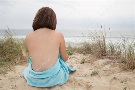 Beautiful Woman Nude Sitting From The Back On Beach Stock Photo