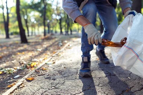 Young Man Picking Up Trash Stock Photo Image Of Environmental 60604570