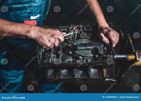 Auto Mechanic Repairing A Car Engine Repair Service In The Garage