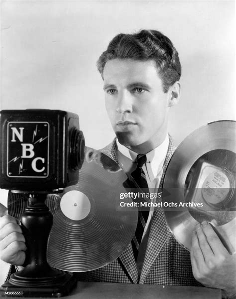 Actor Ozzie Nelson Poses For A Portrait With A Vintage Nbc Microphone