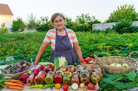 Premium Photo Senior Woman Preserving Vegetables In Jars Selective Focus