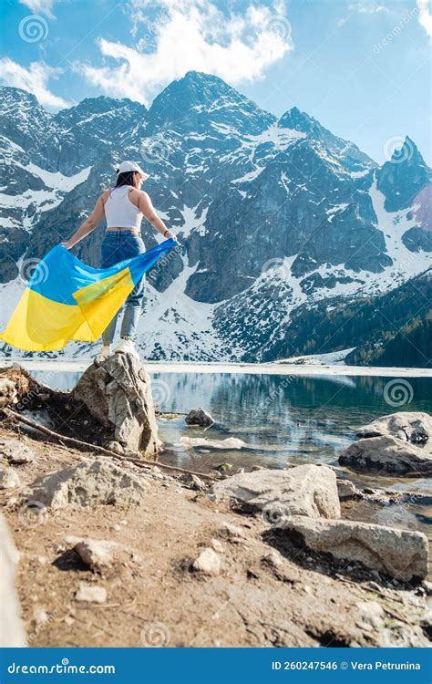 A Woman With Ukrainian Flag Is Standing On The Shore Of A Lake Morskie