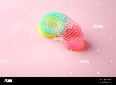 Rainbow slinky on color background Stock Photo - Alamy