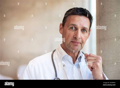 Mature Doctor Clenching Fist In Hospital Stock Photo Alamy