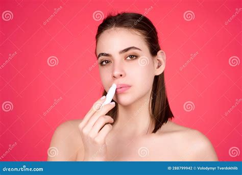 Beautiful Young Woman Applying Red Lipstick On Lips Studio Color