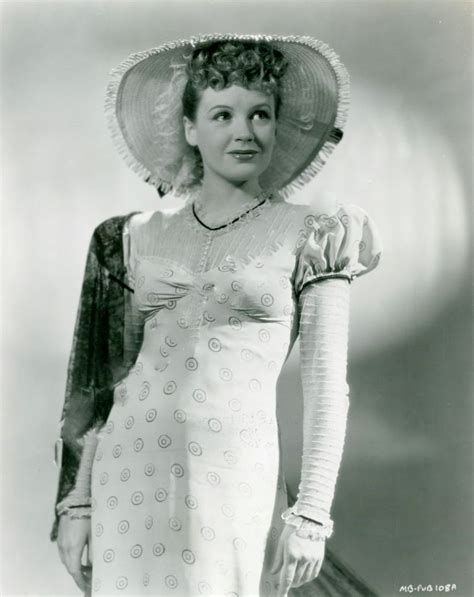 An Old Black And White Photo Of A Woman In A Dress With A Large Hat