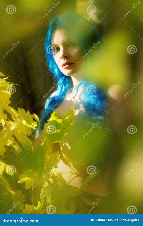 Beautiful Young Unconventional Woman Emo With Individual Blue Hairs Peers Out In Autumn Forest