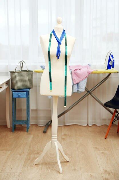 Premium Photo Tailor Dummy With Measuring Tapes In Fashion Studio