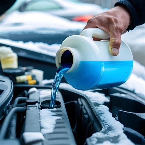 Close Up Car Engine With Hand Pouring Blue Antifreeze Into Radiator In