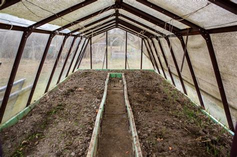 Rural Greenhouse with a Metal Frame Encompasses a Narrow Pathway Running through Its Soil Stock ...