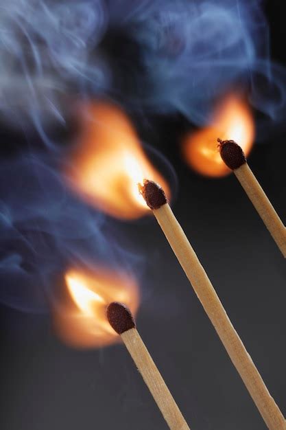 Premium Photo Close Up Of Burning Matchstick Against Wall