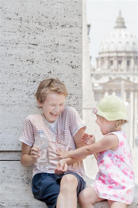 Two Siblings Having Fun With Water From Plastic Bottle In Hot Summer Day Stock Image Image Of