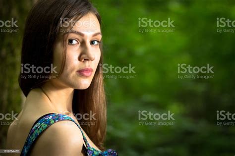 Beautiful Young Woman Wearing Elegant White Dress Walking On A Forest