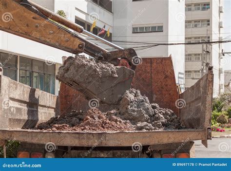 Excavator Working Machine Loading Soil Or Sand Into Truck Body Stock