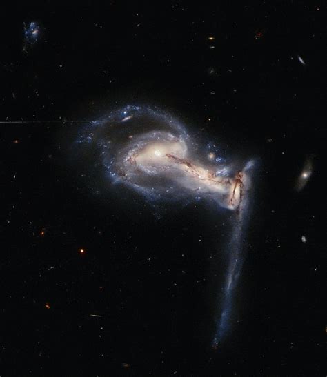 New Hubble Image Captures 3 Galaxies Caught In A Gravitational Tug Of War