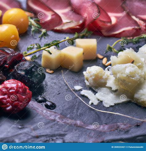 Image Of Close Up Of Plate Of Cold Foods With Meat And Cheese On Grey