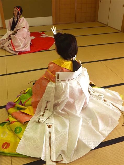 A Woman And A Girl Dressed In Heian Robes At A Kimono Demonstration In