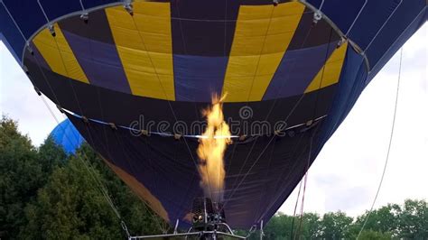 View Of Hot Air Balloon Burner Directing Flame Into Envelope Floating In Sky Stock Photo