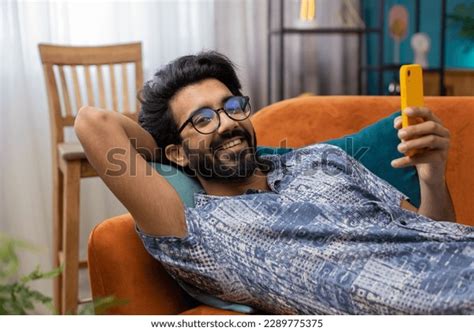 Indian Man Lying On Couch Uses Stock Photo Shutterstock