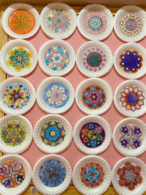 Paper Plates With Colorful Designs Are Arranged On A Pink Surface