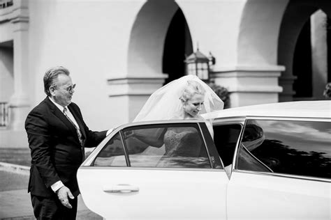 Black and White Photo of Bride Getting into Limo