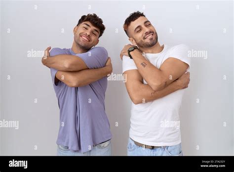 Homosexual Gay Couple Standing Over White Background Hugging Oneself