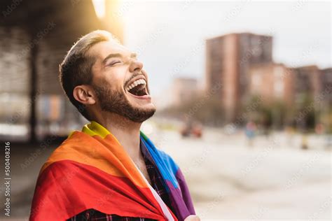 Happy Gay Man Having Fun Holding Rainbow Flag Symbol Of Lgbtq Community Stock Photo Adobe Stock