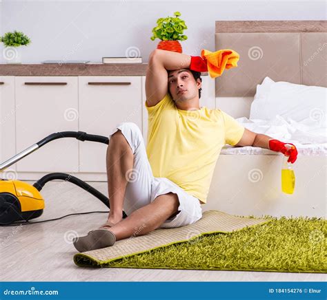 Young Handsome Man Cleaning In The Bedroom Stock Photo Image Of