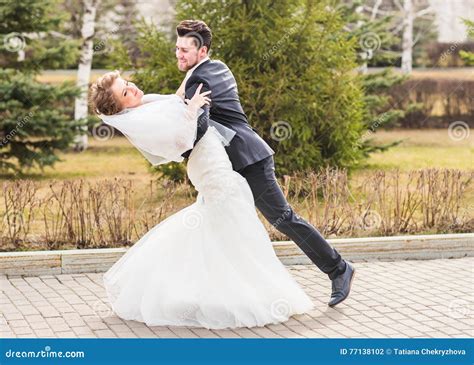 Groom Holding Bride In Dance Pose On Wedding Day Stock Photo Image Of