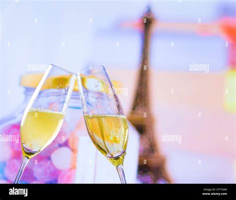 A Pair Of Champagne Flutes With Golden Bubbles Make Cheers On Blur Tower Eiffel Background