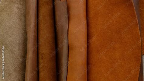 Genuine leather in warm brown tones. Rolls of genuine leather. Fabric texture. Genuine leather ...