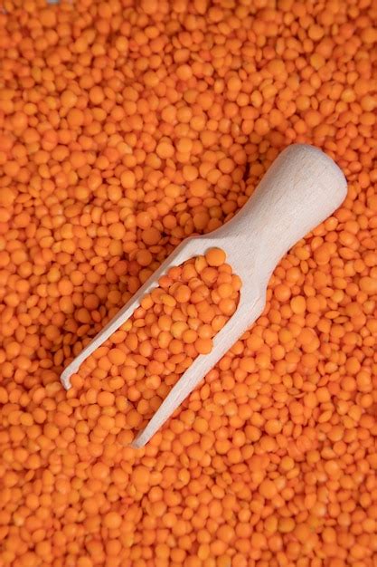 Free Photo A Wooden Spoon Full Of Uncooked Red Lentils