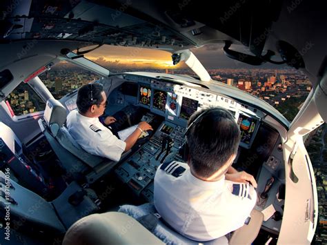 Cockpit of modern passenger jet aircraft. Pilots at work. Aerial view ...