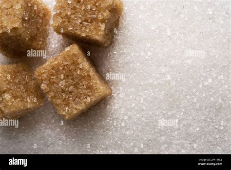 White Refined Sugar Granules And Brown Sugar Cubes Close Up Food