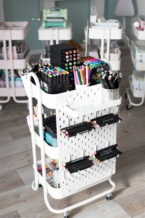 A White Cart Filled With Lots Of Pens And Pencils