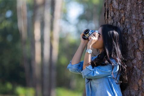 Premium Photo Woman Photographing On Tree Trunk