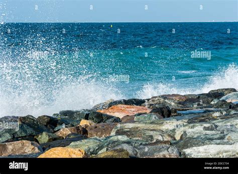 Waves Of Persian Gulf Splashing The Stones Of Breakwater At The