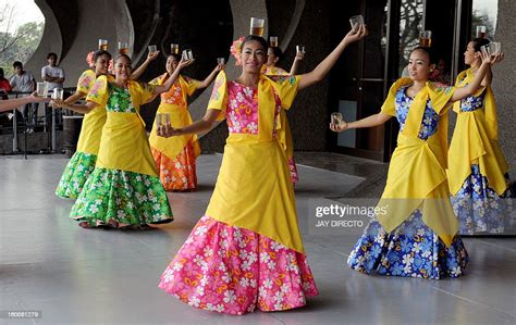 Filipino dancers perform the Binasuan, a dance using glasses with ...