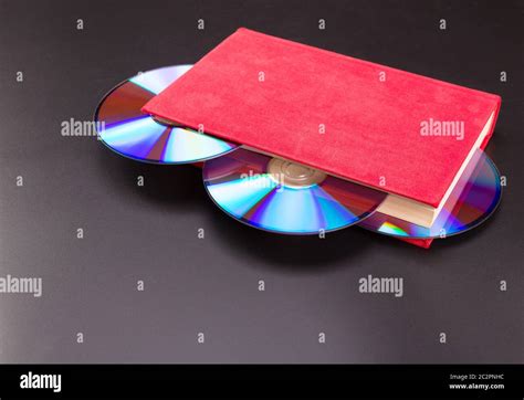 Disks Stick Out From Red Book Stock Photo Alamy