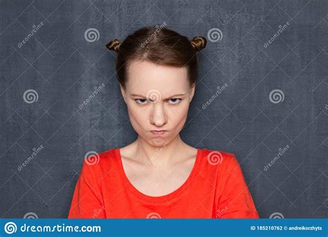 Portrait Of Funny Angry Girl Looking With Displeasure At Camera Stock