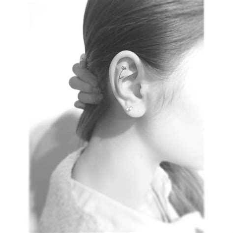 Tiny Flowers Tattoo Located On The Ear Fine Line