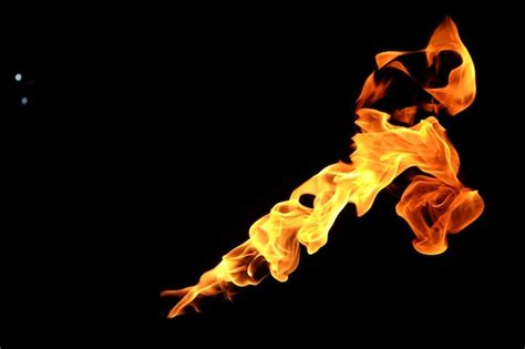 Premium Photo | Yellow fire flames isolated on a black background