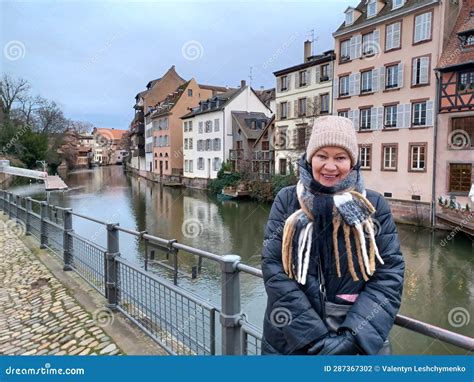Close Up Portrait Mature Woman At The Amazing Traditional Colorful Houses In La Petite France